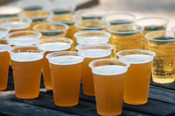 istock Bar counter full of beer in plastic glasses. 1432696647