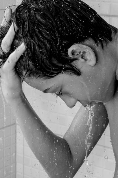 istock Fun and happy boy enjoying his bath while he stands under running water. 1432697099