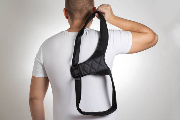 istock A man in a white T-shirt with a black posture corrector on a white background. Back pain and problem correction concept, treatment 1432697247