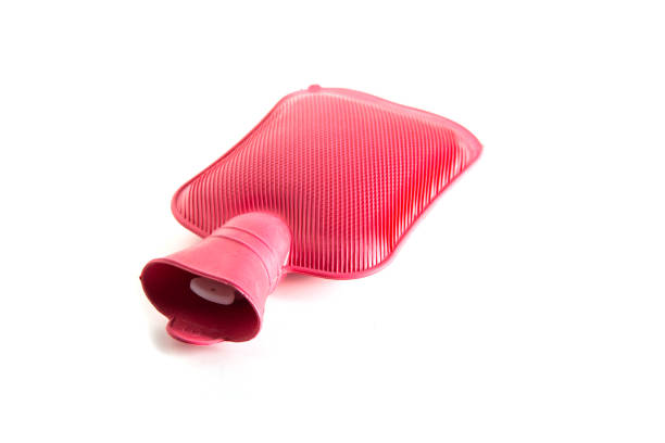 Red medical heating pad with hot water on a white background, isolate. Close-up