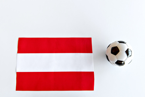 Soccer ball and Austria flag on white background.