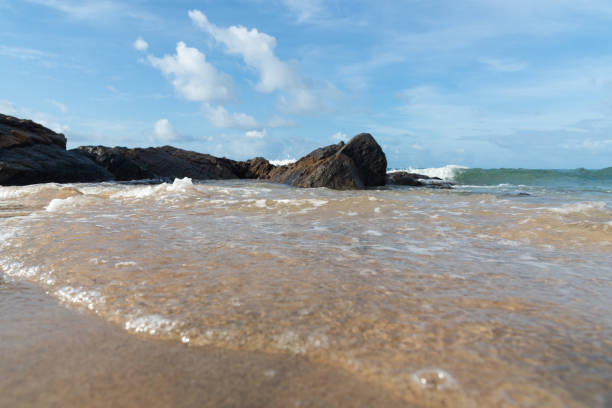 istock A wave breaks about a rock during a curtain on the sea. 1432699114