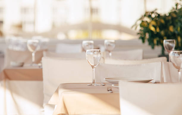 istock Empty wine glass standing on the table tablecloth. Luxury white colors restaurant indoor shot. 1432699748