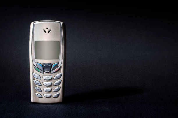 istock Old Silver and Gold Phone with Buttons on Black 1432700203