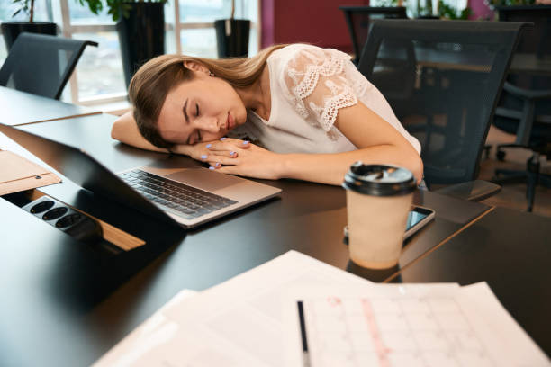 istock Exhausted young company employee napping at laptop 1432700289