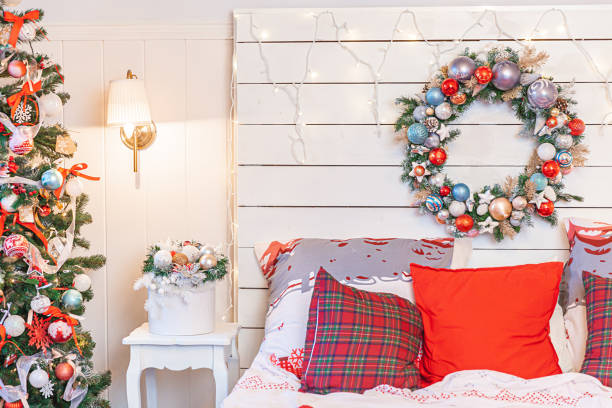istock Classic interior room with Christmas tree and traditional white red decorations. Modern clean white classical style interior design apartment bedroom. Christmas eve at home. Minimalist home design. 1432702465