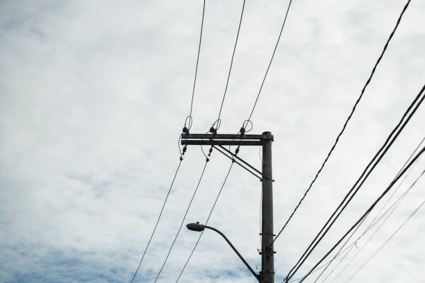 istock Utility pole with electric wires against blue cloudy sky. 1432703809