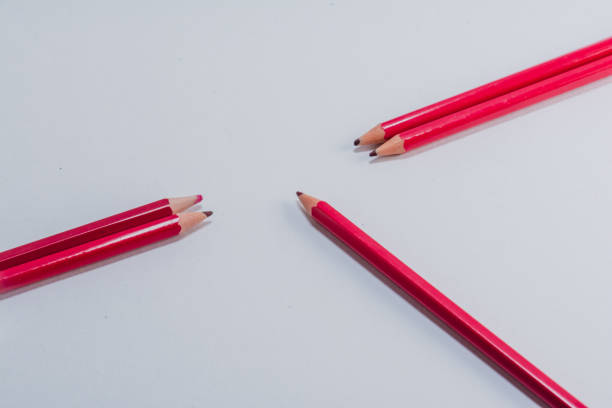 Red wooden pencils isolated on white background. close up