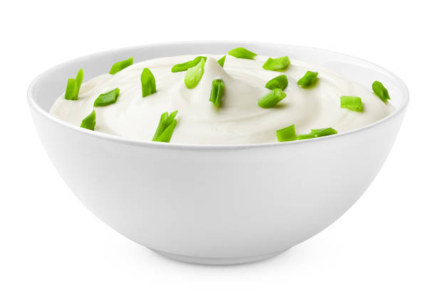 sour cream with onion in bowl, isolated on white background, clipping path, full depth of field stock photo