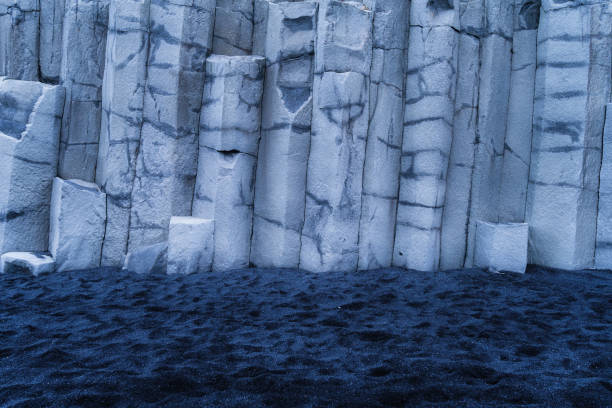 Basalt stones as a background. Reynisfjara Beach, Iceland. Sharp rocks. Photography for design. Textures in nature.