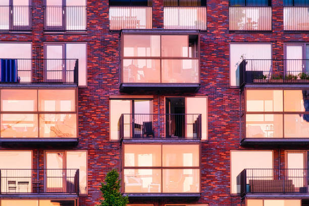 istock A lot of windows on a skyscraper building. Urban textures and backgrounds. Modern architecture and design. Building details. Balcony on an apartment building. 1432706045