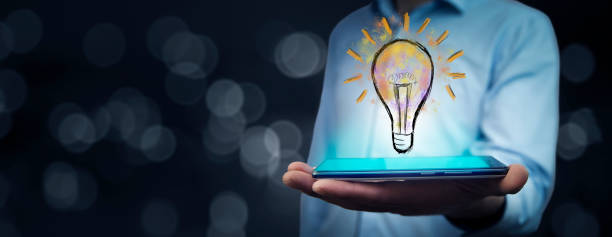istock businessman holding tablet with lighting bulb 1432706862