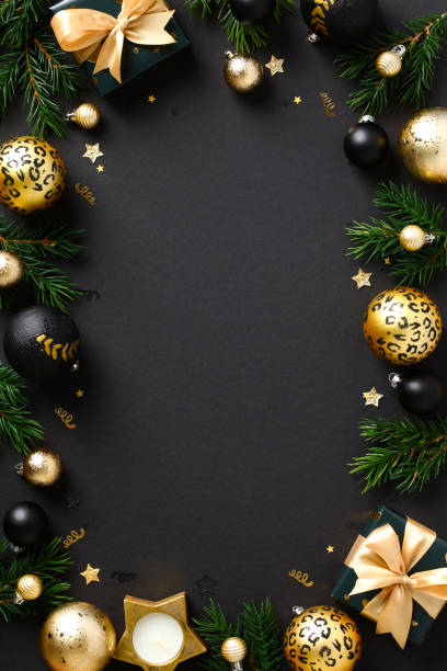 istock Christmas poster design. Luxury golden balls, decorations, Christmas tree branches, gift boxes on black background. Vertical New Year banner template. 1432707259