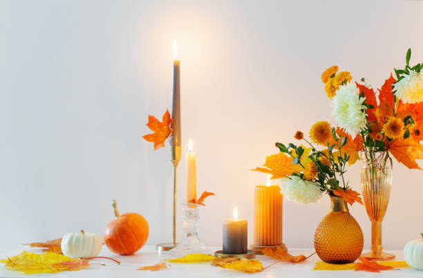 istock beautiful autumn home decor with burning candles in white interior 1432707517