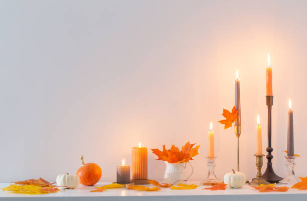 istock beautiful autumn home decor with burning candles in white interior 1432707523