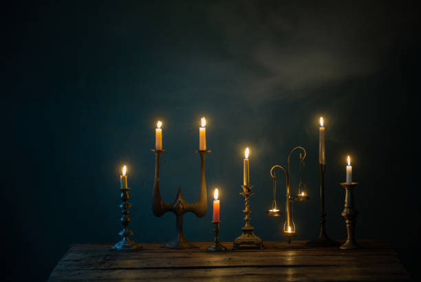 istock burning candles in vintage candlesticks on dark background 1432707581