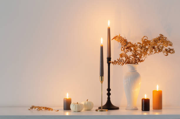 istock beautiful autumn home decor with burning candles in white interior 1432710164