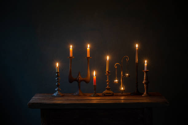 istock burning candles in vintage candlesticks on dark background 1432710211