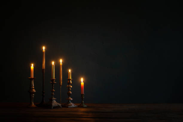 istock burning candles in vintage candlesticks on dark background 1432710221