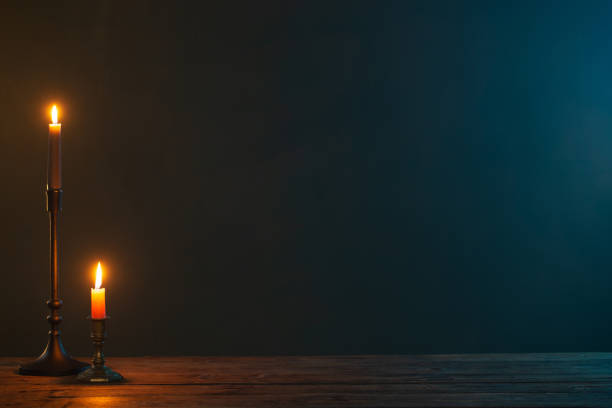 istock burning candles in vintage candlesticks on dark background 1432710223