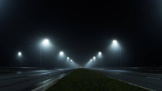 istock thick night fog on a lighted highway . dangerous road conditions 1432710877
