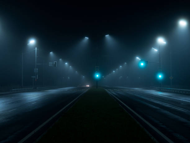 istock thick night fog on a lighted highway . dangerous road conditions 1432710881