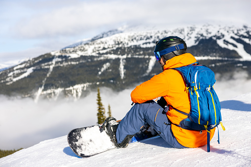 Snowboarder looking at Panorama at Whistler Blackcomb ski Resort, BC, Canada