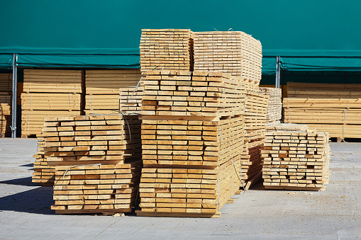 warehouse of sawn and packed wooden boards at a sawmill.