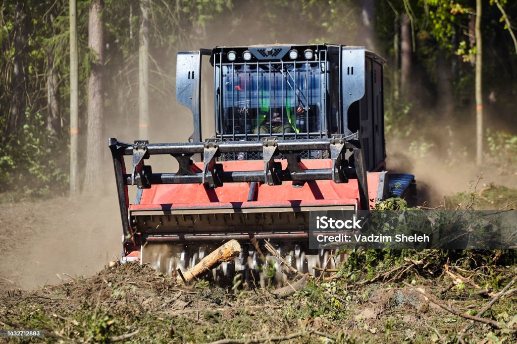 forest mulcher that cleans the soil in the forest. tracked general purpose vehicles used for vegetation and biomass management forest mulcher that cleans the soil in the forest. tracked general purpose vehicles used for vegetation and biomass management. Lumber Industry Stock Photo