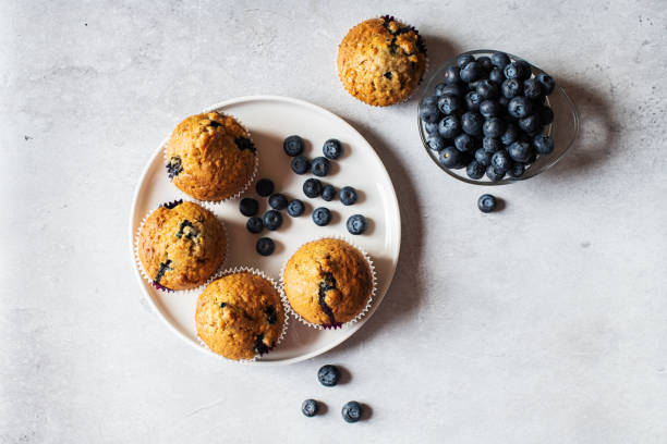 istock Blueberry muffins served in a plate on a marble background. Top view. 1432712968