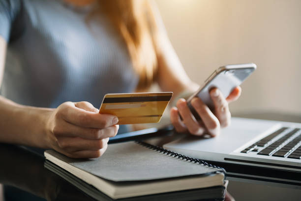 istock Business woman hands using smartphone and holding credit card 1432713401