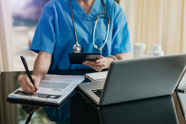 istock Medical technology concept. Doctor working with mobile phone and stethoscope and digital tablet laptop in modern office at hospital 1432713410