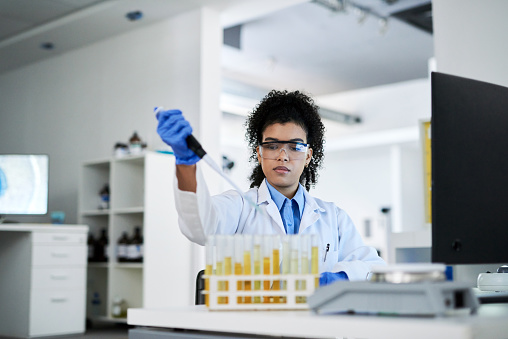 Science, research and innovation with a woman engineer working in her lab with a dropper and medical sample. Analytics, development and breakthrough with a female scientist at work in a laboratory