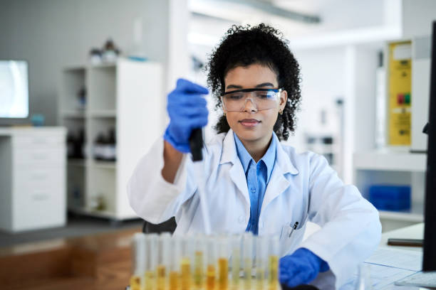 istock Woman scientist, lab and research experiment for testing, cure and scientific discovery with tubes. Black African American female researcher in science working with chemical test tube in laboratory 1432720098