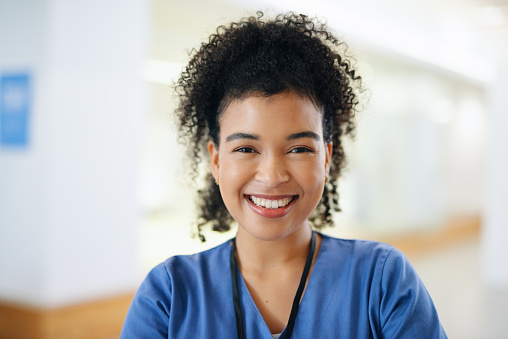 Nurse, smile and black woman at hospital in portrait while working in health, medical and wellness industry. Girl, doctor and medic happy in workplace at clinic, nursing or healthcare in Toronto