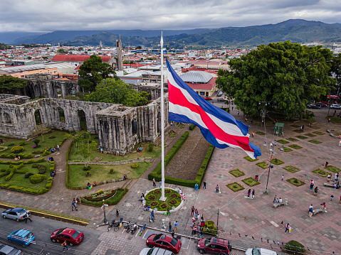 Beautiful aerial night view of the city of Cartago ruines and the Bicentennial monuments and the Costa Rica Flag