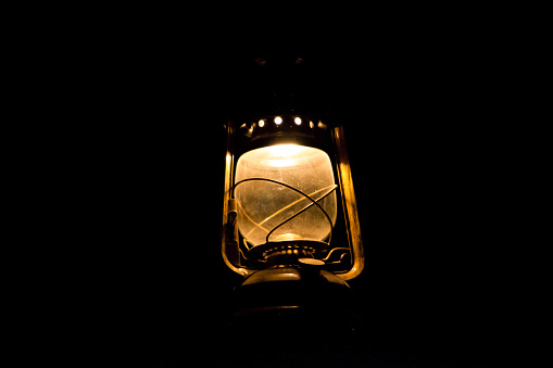 Old fashioned street lamp during rain in the dark