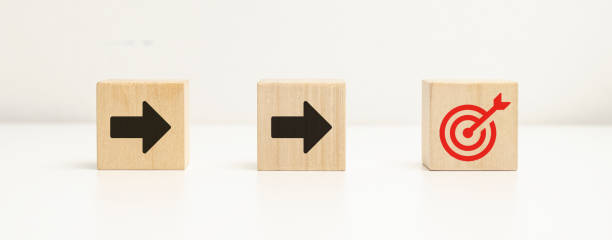 istock Wooden cube blocks with arrow and target symbols. Setting goals for work and business. concept of success business. 1432731927