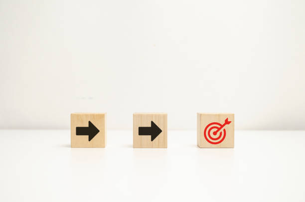 istock Wooden cube blocks with arrow and target symbols. Setting goals for work and business. concept of success business. 1432731932