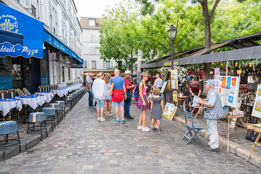 Paris, France - August 26 2022: People, artists, shops in Mormartre village, famous for its artistic heritage