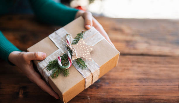 istock Woman hands holding handmade present. 1432736446