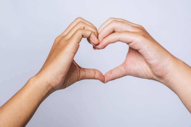 istock Two young women love each other hand mark heart shape. 1432738295