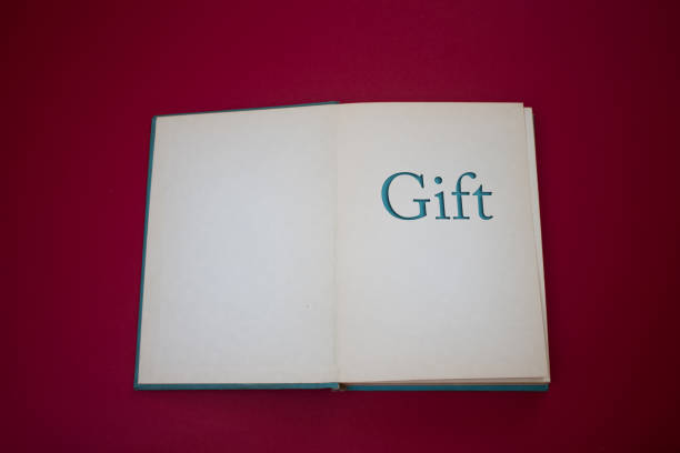 istock Gift word in opened book with vintage, natural patterns old antique paper design. 1432742922