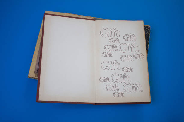 istock Gift word in opened book with vintage, natural patterns old antique paper design. 1432742942