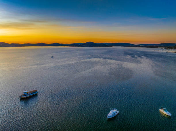 istock Aerial sunrise waterscape with boats and high cloud 1432747169