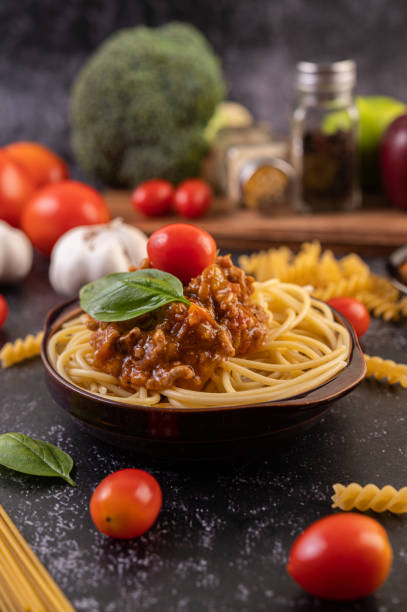 istock Spaghetti saute in a gray plate with tomatoes and basil 1432748621