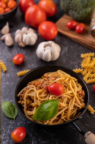 istock Spaghetti sauteed in a pan-fried with tomatoes and basil 1432748778