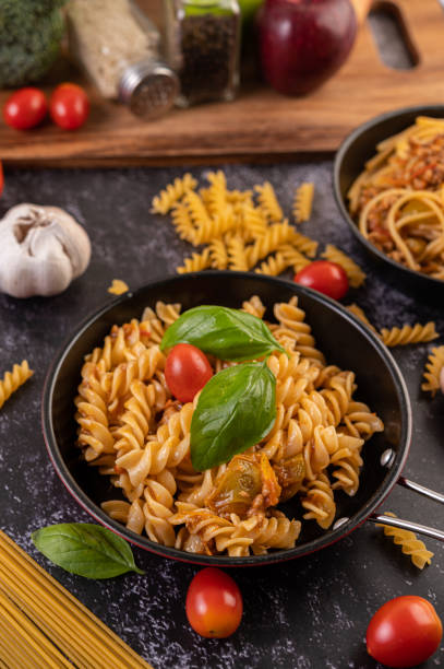 istock Macaroni sauteed with tomatoes and basil on the pan 1432748878