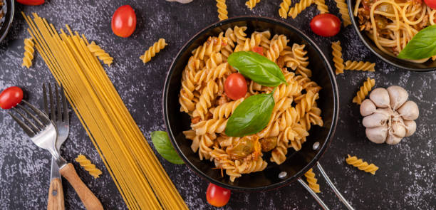 istock Macaroni sauteed with tomatoes and basil on the pan 1432748911