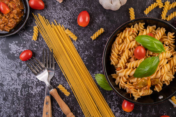 istock Macaroni sauteed with tomatoes and basil on the pan 1432748947
